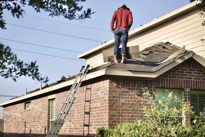 Professional roofer working on a residential roof in Darby Meadows